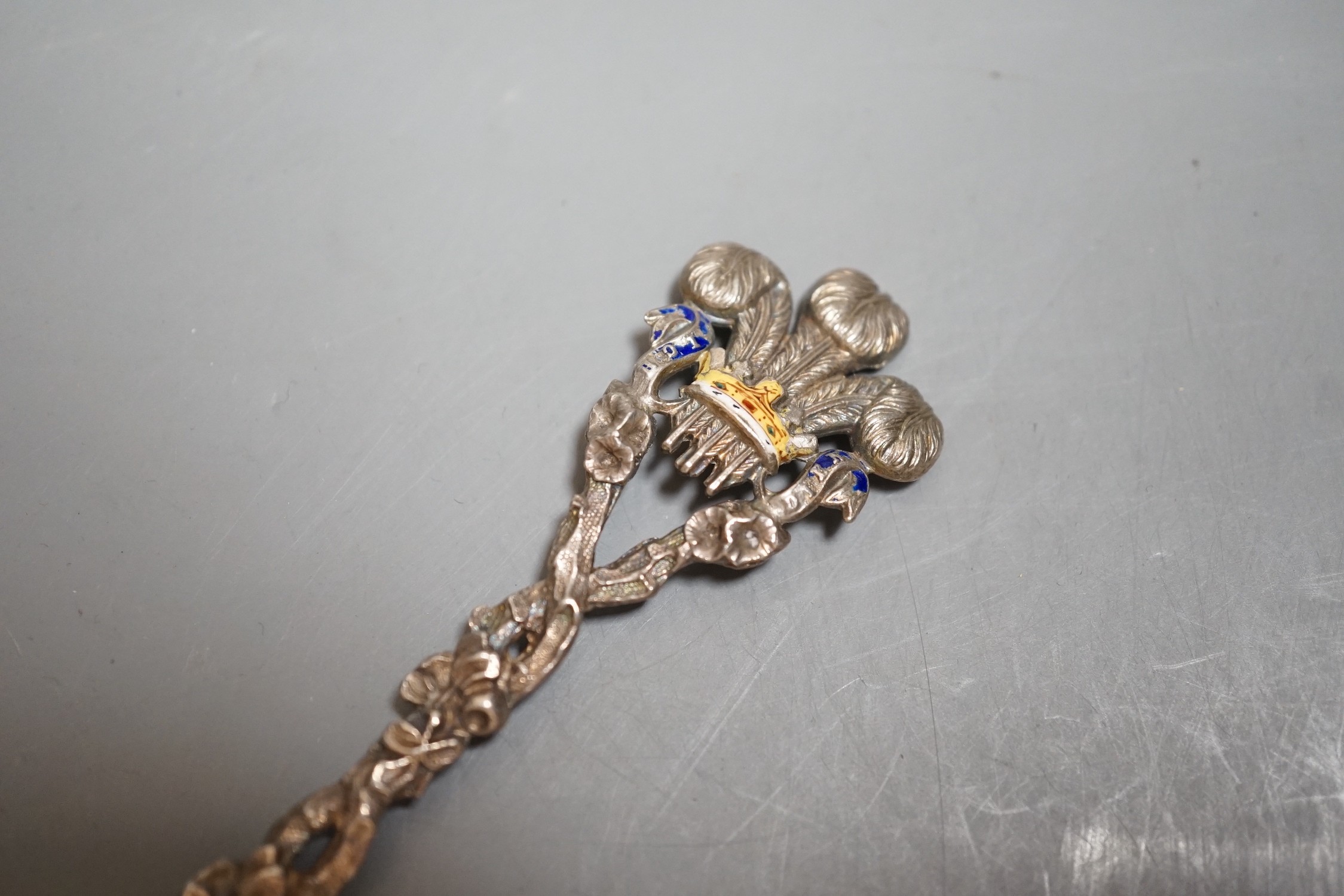 A late Victorian silver and enamelled spoon, with rustic stem and Prince of Wales feathers terminal, the bowl engraved with the Royal Coat of Arms, Saunders & Shepherd, London, 1896, 20.2cm, gross 43 grams.